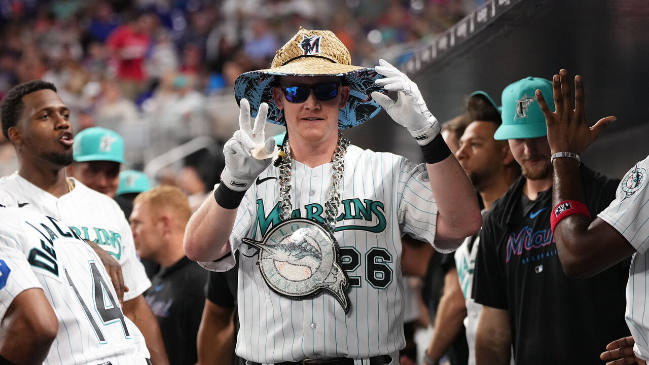 MIAMI, FLORIDA - JULY 7: Garrett Cooper #26 of the Miami Marlins celebrates with teammates in the dugout after hitting a solo home run in the game against the Philadelphia Phillies at loanDepot park on July 7, 2023 in Miami, Florida.