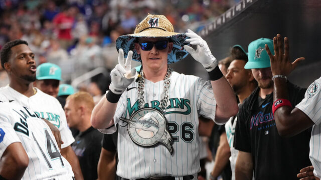 MIAMI, FLORIDA - JULY 7: Garrett Cooper #26 of the Miami Marlins celebrates with teammates in the dugout after hitting a solo home run in the game against the Philadelphia Phillies at loanDepot park on July 7, 2023 in Miami, Florida.