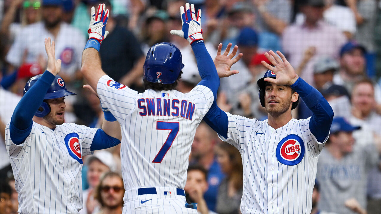 CHICAGO, ILLINOIS - AUGUST 01: Ian Happ #8 and Cody Bellinger #24 celebrates after Dansby Swanson #7 of the Chicago Cubs hit a two-run home run in the first inning against Ben Lively of the Cincinnati Reds at Wrigley Field on August 01, 2023 in Chicago, Illinois.