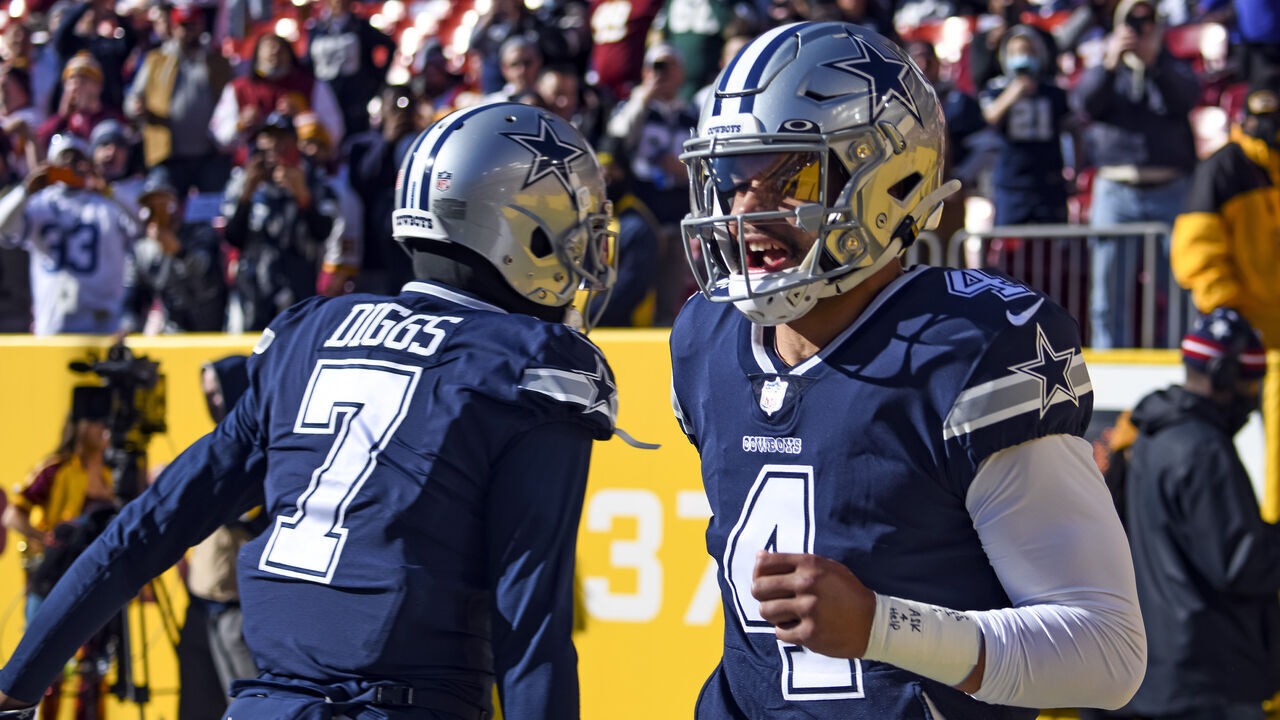 LANDOVER, MD - DECEMBER 12: Dallas Cowboys quarterback Dak Prescott (4) takes the field with cornerback Trevon Diggs (7) for the NFL game between the Dallas Cowboys and the Washington Football Team on December 12, 2021 at Fed Ex Field in Landover, MD.