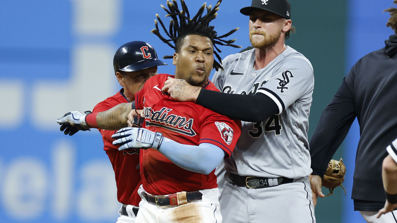 CLEVELAND, OH - AUGUST 05: Jose Ramirez #11 of the Cleveland Guardians is held by Michael Kopech #34 of the Chicago White Sox during a fight in the sixth inning at Progressive Field on August 05, 2023 in Cleveland, Ohio.