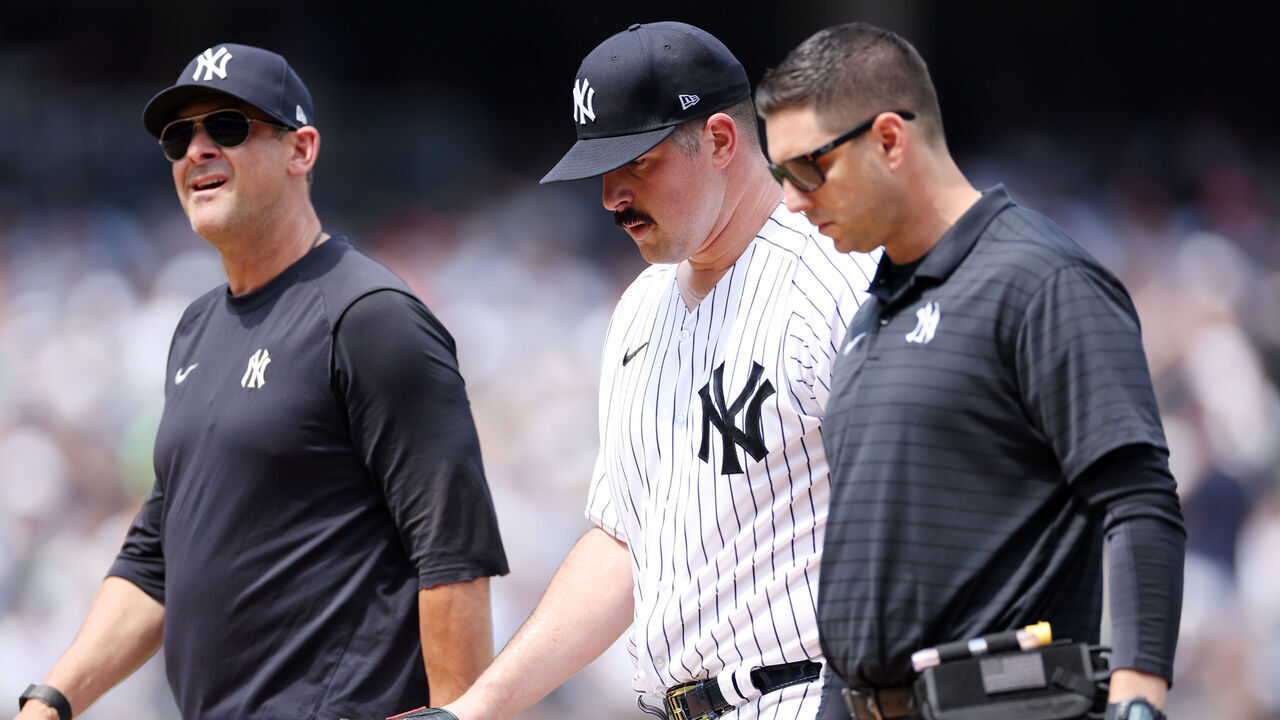 NEW YORK, NEW YORK - AUGUST 06: Carlos Rodon #55 of the New York Yankees leaves the game with manager Aaron Boone #17 during the third inning against the Houston Astros at Yankee Stadium on August 06, 2023 in the Bronx borough of New York City.
