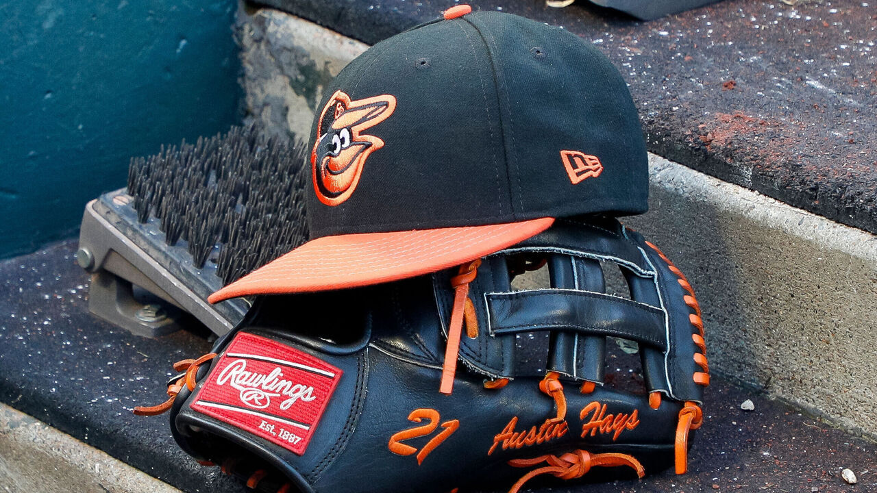 SAN FRANCISCO, CA - JUNE 03: A hat and glove belonging to Baltimore Orioles left fielder Austin Hays (21) in the dugout during a regular season game between the Baltimore Orioles and San Francisco Giants on June 3, 2023 at Oracle Park in San Francisco, CA.