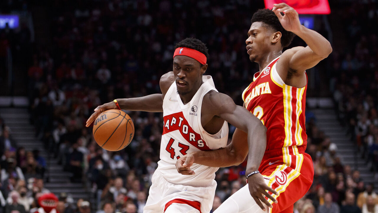 TORONTO, ON - APRIL 05: Pascal Siakam #43 of the Toronto Raptors drives against De'Andre Hunter #12 of the Atlanta Hawks during the second half of their NBA game at Scotiabank Arena on April 5, 2022 in Toronto, Canada.