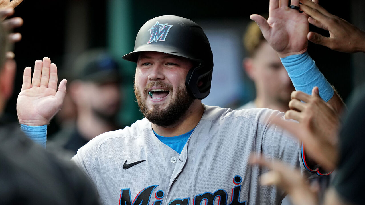 CINCINNATI, OHIO - AUGUST 08: Jake Burger #36 of the Miami Marlins celebrates with teammates in the dugout after hitting a home run in the second inning against the Cincinnati Reds at Great American Ball Park on August 08, 2023 in Cincinnati, Ohio.