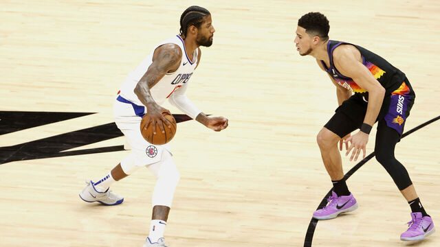 PHOENIX, ARIZONA - JUNE 22: Paul George #13 of the LA Clippers controls the ball ahead of Devin Booker #1 of the Phoenix Suns during the third quarter in game two of the NBA Western Conference finals at Phoenix Suns Arena on June 22, 2021 in Phoenix, Arizona.
