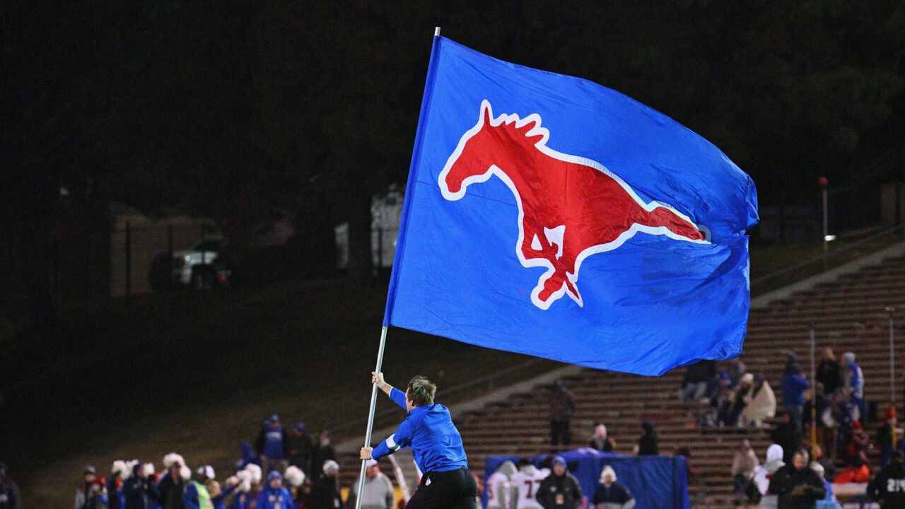ALBUQUERQUE, NEW MEXICO - DECEMBER 17: An SMU Mustangs cheerleader carries a flag on the field after the Mustangs scored a touchdown during the second half of the New Mexico Bowl game between the Mustangs and the Brigham Young Cougars at University Stadium on December 17, 2022 in Albuquerque, New Mexico. The Cougars defeated the Mustangs 24-23.