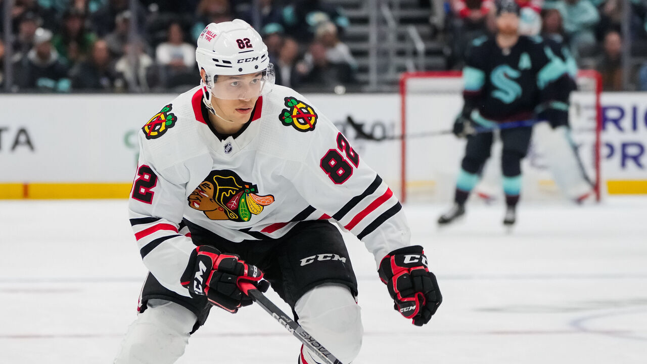 SEATTLE, WASHINGTON - APRIL 08: Caleb Jones #82 of the Chicago Blackhawks skates back for the puck during the first period of a game against the Seattle Kraken at Climate Pledge Arena on April 08, 2023 in Seattle, Washington.