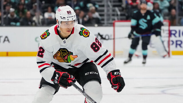 SEATTLE, WASHINGTON - APRIL 08: Caleb Jones #82 of the Chicago Blackhawks skates back for the puck during the first period of a game against the Seattle Kraken at Climate Pledge Arena on April 08, 2023 in Seattle, Washington.