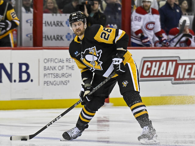 PITTSBURGH, PA - MARCH 14: Pittsburgh Penguins Defenseman Jeff Petry (26) passes the puck during the second period in the NHL game between the Pittsburgh Penguins and the Montreal Canadiens on March 14, 2023, at PPG Paints Arena in Pittsburgh, PA.