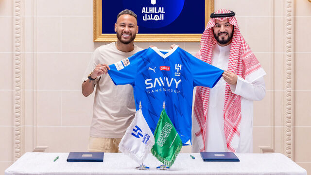 RIYADH, SAUDI ARABIA - AUGUST 15: (----EDITORIAL USE ONLY â" MANDATORY CREDIT - 'AL HILAL SAUDI CLUB' - NO MARKETING NO ADVERTISING CAMPAIGNS - DISTRIBUTED AS A SERVICE TO CLIENTS----) Brazilian football star Neymar (L) and Al-Hilal's president Fahad bin Nafel (R) pose for a photo with an Al Hilal jersey as Neymar joins Al-Hilal with a two-year contract in Riyadh, Saudi Arabia on August 15, 2023.