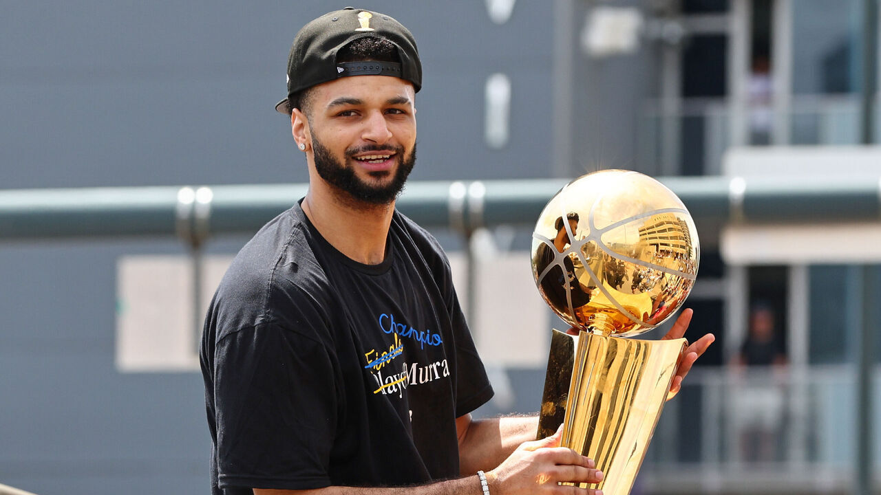 DENVER, CO - JUNE 15: Jamal Murray #27 of the Denver Nuggets celebrates with the Larry O'Brien Trophy during the 2023 Denver Nuggets Championship Parade on June 15, 2023 in Denver, Colorado. NOTE TO USER: User expressly acknowledges and agrees that, by downloading and/or using this Photograph, user is consenting to the terms and conditions of the Getty Images License Agreement. Mandatory Copyright Notice: Copyright 2023 NBAE