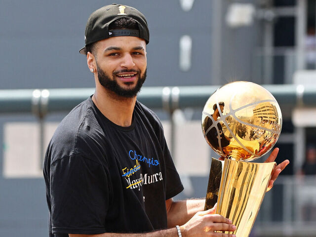 DENVER, CO - JUNE 15: Jamal Murray #27 of the Denver Nuggets celebrates with the Larry O'Brien Trophy during the 2023 Denver Nuggets Championship Parade on June 15, 2023 in Denver, Colorado. NOTE TO USER: User expressly acknowledges and agrees that, by downloading and/or using this Photograph, user is consenting to the terms and conditions of the Getty Images License Agreement. Mandatory Copyright Notice: Copyright 2023 NBAE