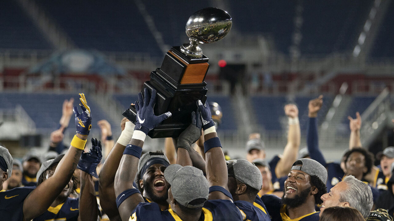 BOCA RATON, FL - DECEMBER 20: Toledo Rockets lift the RoofClaim.com Boca Raton Bowl Howard Schnelinberger Championship Trophy after the RoofClaim.com Boca Raton Bowl between the Liberty Flames and the Toledo Rockets at FAU Stadium in Boca Raton, FL on December 20th, 2022. Toledo Rockets won 21-19.