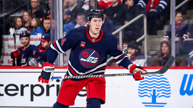 WINNIPEG, CANADA - MARCH 31: Logan Stanley #64 of the Winnipeg Jets keeps an eye on the play during third period action against the Detroit Red Wings at the Canada Life Centre on March 31, 2023 in Winnipeg, Manitoba, Canada. The Jets defeated the Wings 6-2.