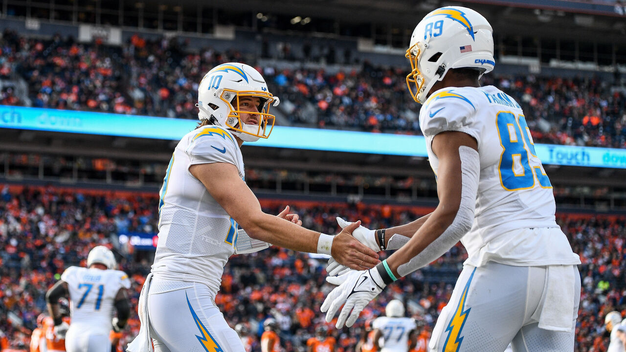 DENVER, CO - JANUARY 8: Los Angeles Chargers quarterback Justin Herbert (10) celebrates with Los Angeles Chargers tight end Donald Parham Jr. (89) after a second quarter touchdown catch during a game between the Los Angeles Chargers and the Denver Broncos at Empower Field at Mile High on January 8, 2023 in Denver, Colorado.