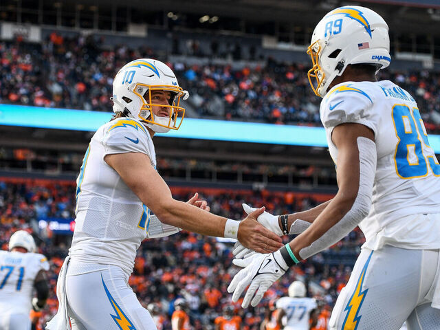 DENVER, CO - JANUARY 8: Los Angeles Chargers quarterback Justin Herbert (10) celebrates with Los Angeles Chargers tight end Donald Parham Jr. (89) after a second quarter touchdown catch during a game between the Los Angeles Chargers and the Denver Broncos at Empower Field at Mile High on January 8, 2023 in Denver, Colorado.