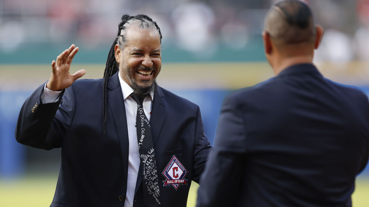 CLEVELAND, OH - AUGUST 19: Former Cleveland baseball player Manny Ramirez reacts after throwing out the ceremonial first pitch to Carlos Baerga after being inducted into the Cleveland Guardians Hall of Fame before a game against the Detroit Tigers at Progressive Field on August 19, 2023 in Cleveland, Ohio.