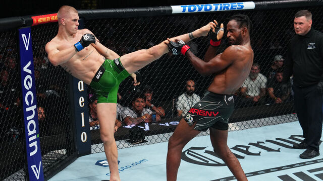 BOSTON, MASSACHUSETTS - AUGUST 19: (L-R) Ian Garry of Ireland kicks Neil Magny in a welterweight fight during the UFC 292 event at TD Garden on August 19, 2023 in Boston, Massachusetts.
