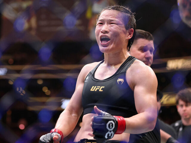 BOSTON, MASSACHUSETTS - AUGUST 19: Zhang Weili of China celebrates after defeating Amanda Lemos during their Strawweight title fight at UFC 292 at TD Garden on August 19, 2023 in Boston, Massachusetts.
