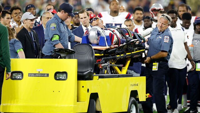 GREEN BAY, WISCONSIN - AUGUST 19: Isaiah Bolden #7 of the New England Patriots is carted off the field after suffering an injury during the second half of the game against the Green Bay Packers during a preseason game at Lambeau Field on August 19, 2023 in Green Bay, Wisconsin.