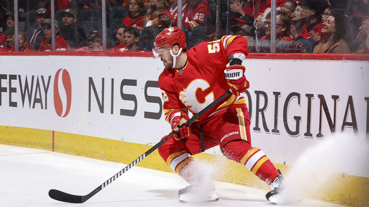 CALGARY, AB - APRIL 10: MacKenzie Weegar #52 of the Calgary Flames protects the puck against the Nashville Predators at Scotiabank Saddledome on April 10, 2023 in Calgary, Alberta, Canada.