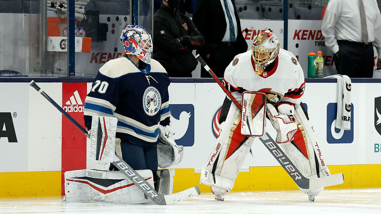 COLUMBUS, OH - JANUARY 23: Joonas Korpisalo #70 of the Columbus Blue Jackets talks with Anton Forsberg #31 of the Ottawa Senators during warmups prior to the start of the game at Nationwide Arena on January 23, 2022 in Columbus, Ohio.