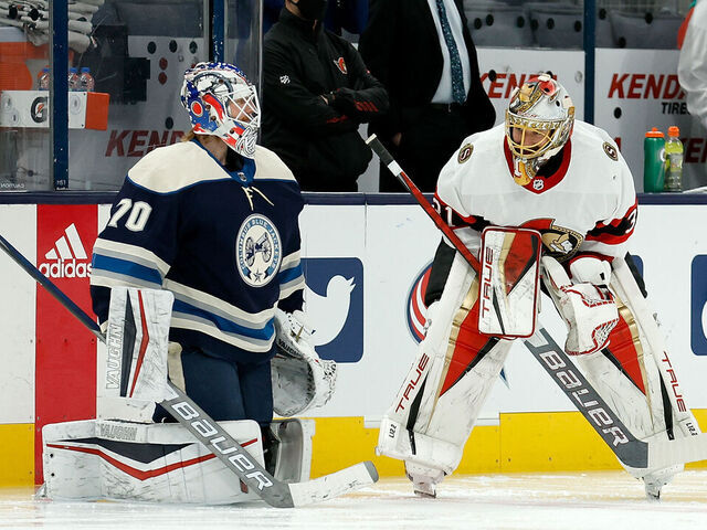 COLUMBUS, OH - JANUARY 23: Joonas Korpisalo #70 of the Columbus Blue Jackets talks with Anton Forsberg #31 of the Ottawa Senators during warmups prior to the start of the game at Nationwide Arena on January 23, 2022 in Columbus, Ohio.