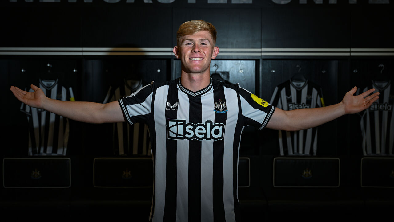 NEWCASTLE UPON TYNE, ENGLAND - AUGUST 18: Lewis Hall poses for photographs in the dressing room wearing a home shirt at St.James' Park on August 18, 2023 in Newcastle upon Tyne, England.