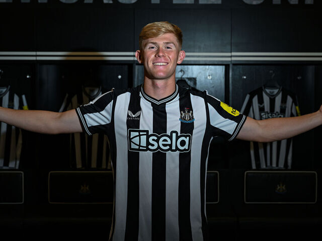 NEWCASTLE UPON TYNE, ENGLAND - AUGUST 18: Lewis Hall poses for photographs in the dressing room wearing a home shirt at St.James' Park on August 18, 2023 in Newcastle upon Tyne, England.