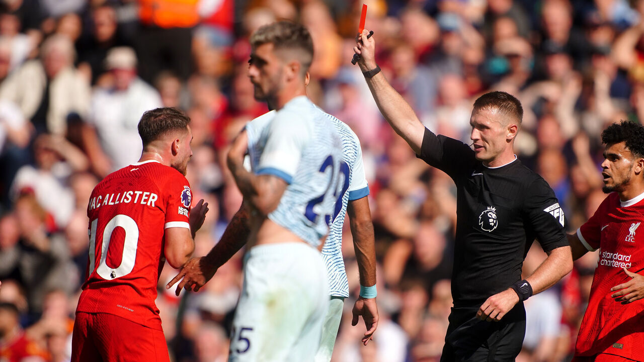 Referee Thomas Bramall shows a red card to Liverpool's Alexis Mac Allister for serious foul play during the Premier League match at Anfield, Liverpool. Picture date: Saturday August 19, 2023.