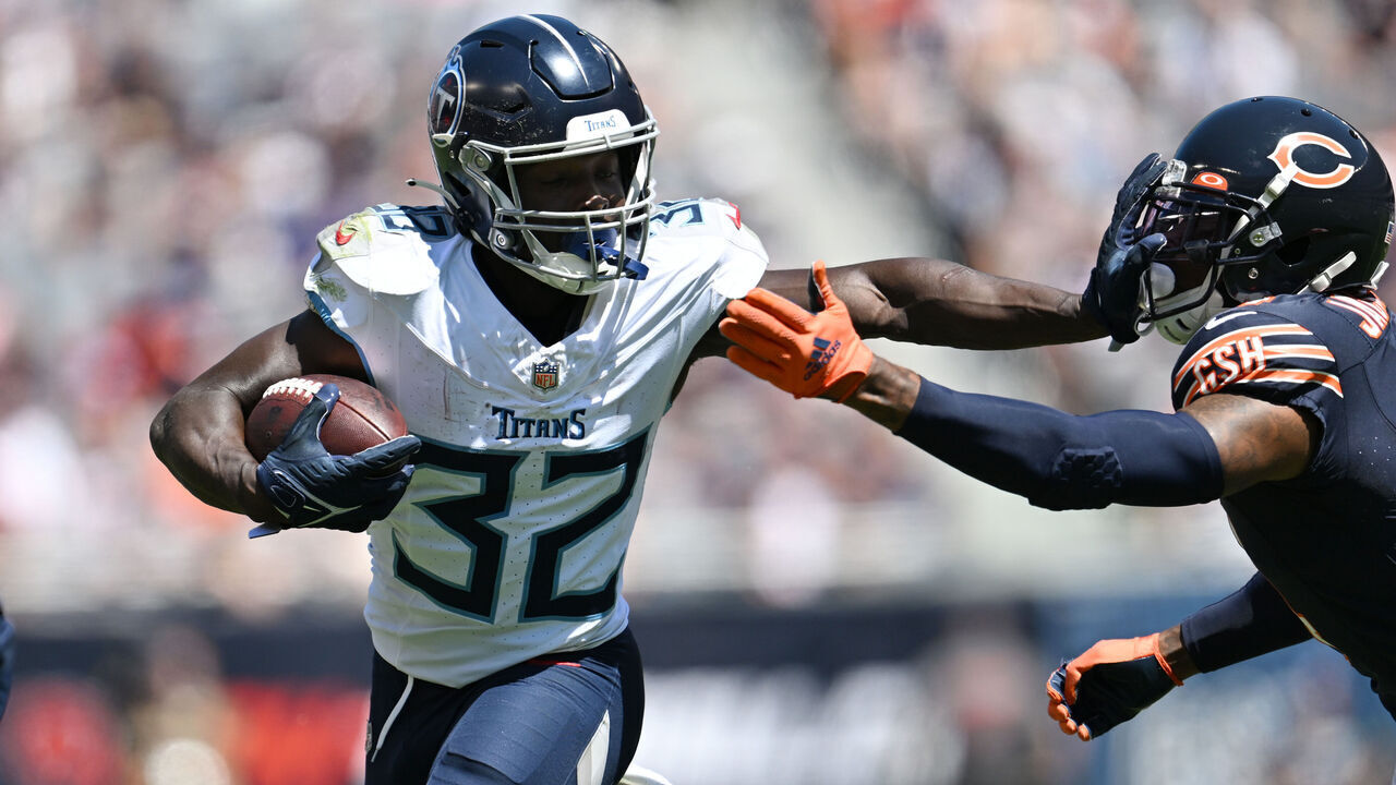 CHICAGO, ILLINOIS - AUGUST 12: Tyjae Spears #32 of the Tennessee Titans stiff arms Eddie Jackson #4 of the Chicago Bears in the first half during a preseason game at Soldier Field on August 12, 2023 in Chicago, Illinois.