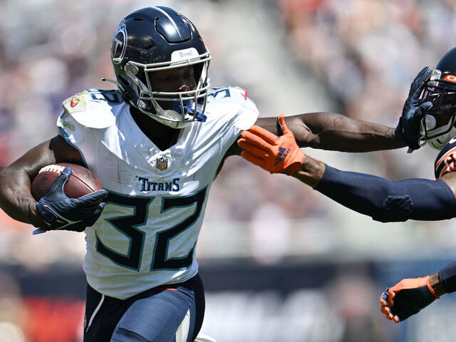 CHICAGO, ILLINOIS - AUGUST 12: Tyjae Spears #32 of the Tennessee Titans stiff arms Eddie Jackson #4 of the Chicago Bears in the first half during a preseason game at Soldier Field on August 12, 2023 in Chicago, Illinois.
