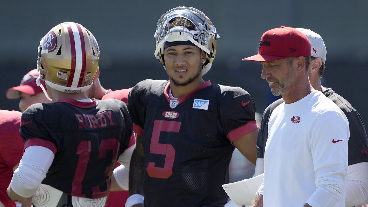 SANTA CLARA, CALIFORNIA - AUGUST 04: Head coach Kyle Shanahan of the San Francisco 49ers talks with his quarterbacks Trey Lance #5 and Brock Purdy #13 during work outs in training camp at SAP Performance Facility on August 04, 2023 in Santa Clara, California.
