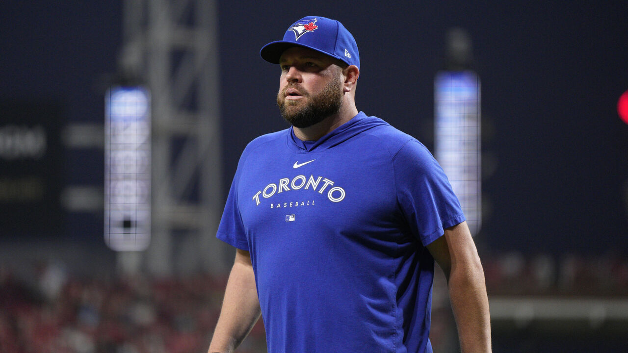 CINCINNATI, OHIO - AUGUST 19: John Schneider #14 of the Toronto Blue Jays walks to the dugout during a baseball game against the Cincinnati Reds at Great American Ball Park on August 19, 2023 in Cincinnati, Ohio.