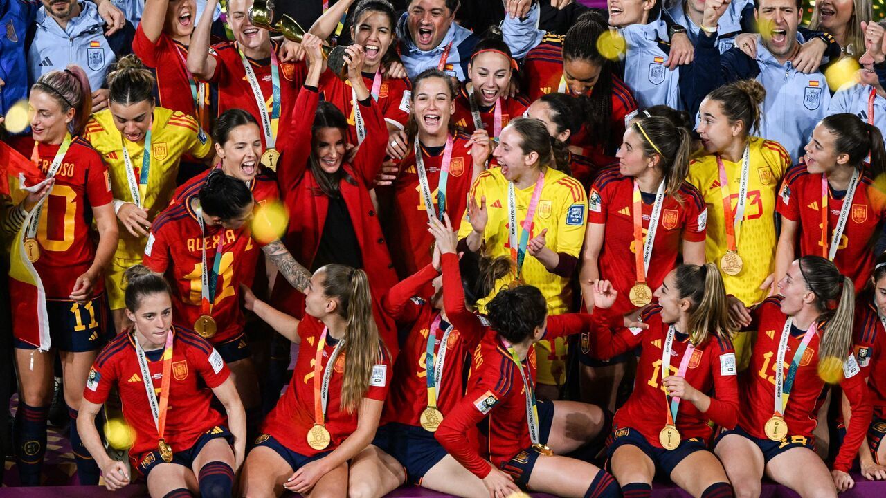 Queen Letizia of Spain lifts the trophy on the podium in celebration after Spain won the Australia and New Zealand 2023 Women's World Cup final football match between Spain and England at Stadium Australia in Sydney on August 20, 2023.