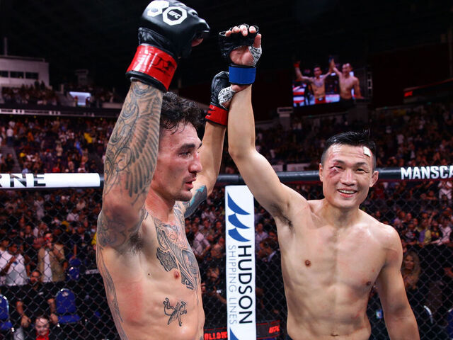 SINGAPORE, SINGAPORE - AUGUST 26: (L-R) Max Holloway and Chan Sung Jung of South Korea react after their featherweight bout during the UFC Fight Night event at Singapore Indoor Stadium on August 26, 2023 in Singapore.