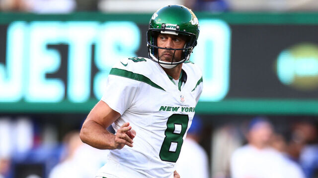 EAST RUTHERFORD, NEW JERSEY - AUGUST 26: Aaron Rodgers #8 of the New York Jets reacts after throwing a first quarter touchdown pass to Garrett Wilson #17 in a preseason game against the New York Giants at MetLife Stadium on August 26, 2023 in East Rutherford, New Jersey.