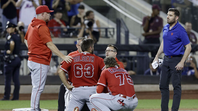 NEW YORK, NEW YORK - AUGUST 26: Chase Silseth #63 of the Los Angeles Angels is checked out on the field after an injury in the fourth inning against the New York Mets at Citi Field on August 26, 2023 in New York City.