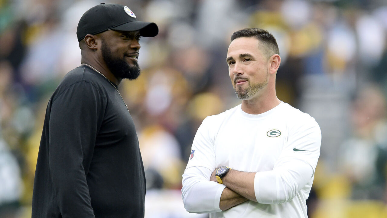 GREEN BAY, WISCONSIN - OCTOBER 03: (L-R) Head coach Mike Tomlin of the Pittsburgh Steelers talks with head coach Matt LaFleur of the Green Bay Packers before the game at Lambeau Field on October 03, 2021 in Green Bay, Wisconsin.
