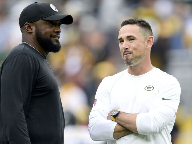 GREEN BAY, WISCONSIN - OCTOBER 03: (L-R) Head coach Mike Tomlin of the Pittsburgh Steelers talks with head coach Matt LaFleur of the Green Bay Packers before the game at Lambeau Field on October 03, 2021 in Green Bay, Wisconsin.