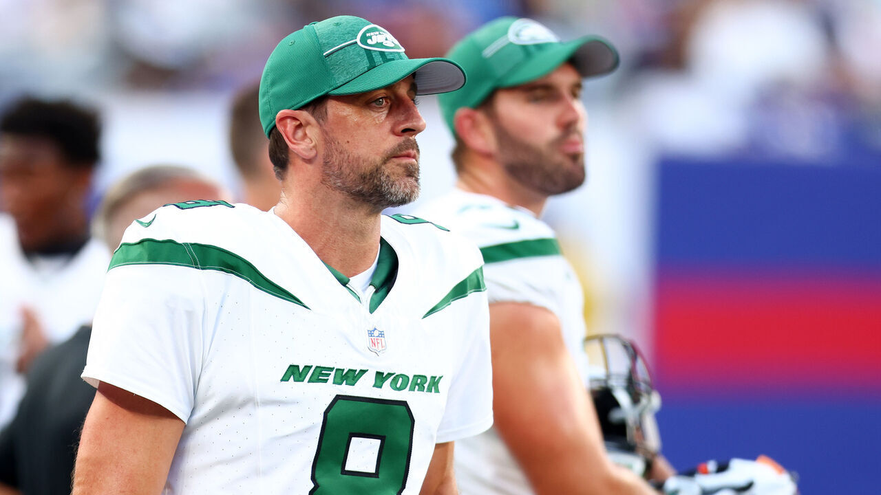 EAST RUTHERFORD, NEW JERSEY - AUGUST 26: Aaron Rodgers #8 of the New York Jets looks on from the sideline during the preseason game against the New York Giants at MetLife Stadium on August 26, 2023 in East Rutherford, New Jersey.