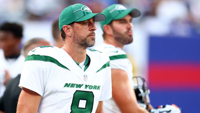 EAST RUTHERFORD, NEW JERSEY - AUGUST 26: Aaron Rodgers #8 of the New York Jets looks on from the sideline during the preseason game against the New York Giants at MetLife Stadium on August 26, 2023 in East Rutherford, New Jersey.