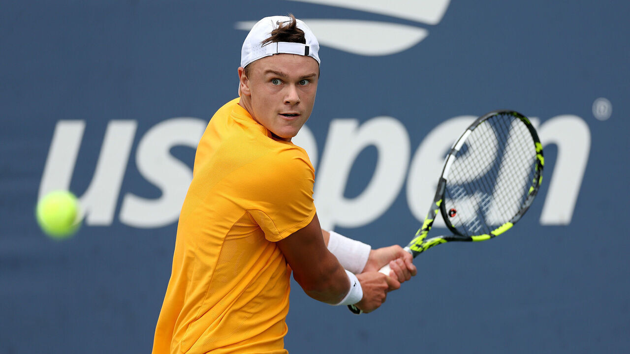 NEW YORK, NEW YORK - AUGUST 28: Holger Rune of Denmark returns a shot against Roberto Carballes Baena of Spain during their Women/Men's Singles First Round match on Day One of the 2023 US Open at the USTA Billie Jean King National Tennis Center on August 28, 2023 in the Flushing neighborhood of the Queens borough of New York City.
