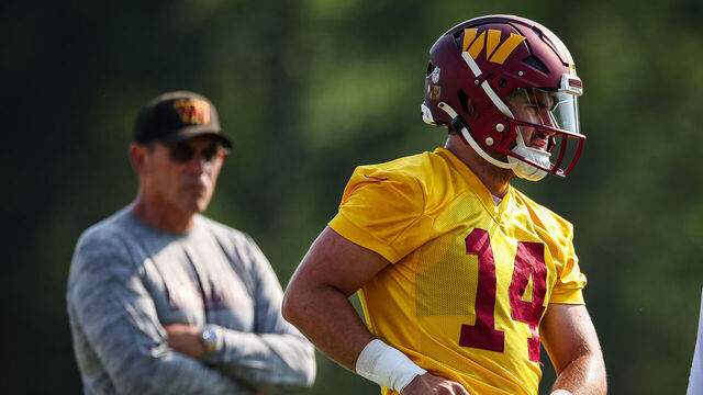 ASHBURN, VA - JULY 28: Head coach Ron Rivera and Sam Howell #14 of the Washington Commanders look on during training camp at OrthoVirginia Training Center on July 28, 2022 in Ashburn, Virginia.