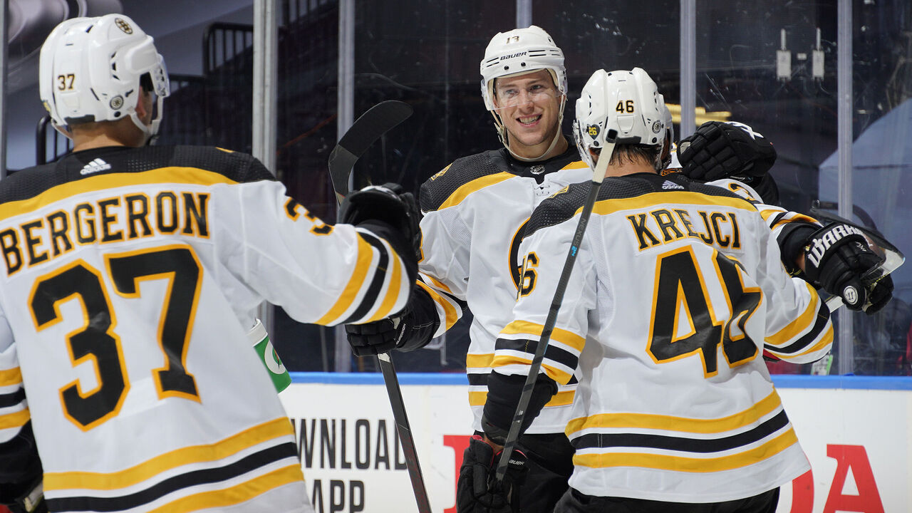 TORONTO, ONTARIO - AUGUST 15: Charlie Coyle #13 of the Boston Bruins celebrates with teammates Patrice Bergeron #37 and David Krejci #46 after Coyle scored a goal against goaltender Petr Mrazek #34 of the Carolina Hurricanes in the second period of Game Three of the Eastern Conference First Round of the 2020 NHL Stanley Cup Playoff between the Boston Bruins and the Carolina Hurricanes at Scotiabank Arena on August 15, 2020 in Toronto, Ontario.