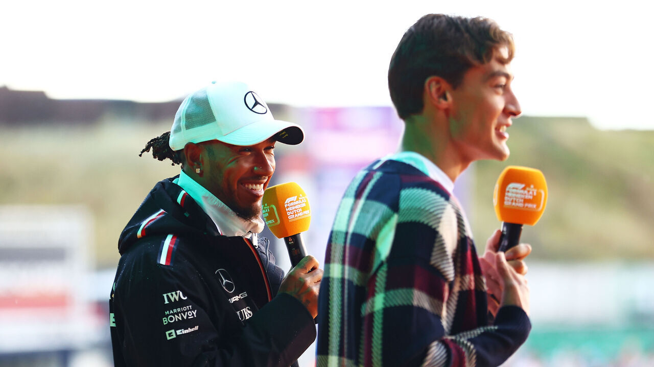 ZANDVOORT, NETHERLANDS - AUGUST 26: Lewis Hamilton of Great Britain and Mercedes and George Russell of Great Britain and Mercedes talk to the crowd on the fan stage prior to final practice ahead of the F1 Grand Prix of The Netherlands at Circuit Zandvoort on August 26, 2023 in Zandvoort, Netherlands.