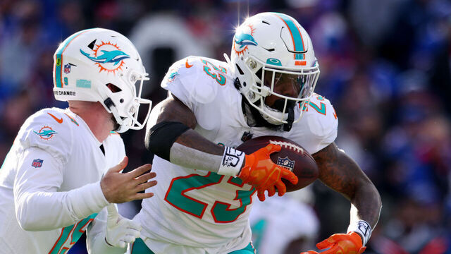 ORCHARD PARK, NEW YORK - JANUARY 15: Jeff Wilson Jr. #23 of the Miami Dolphins carries the ball against the Buffalo Bills during the first half in the AFC Wild Card playoff game at Highmark Stadium on January 15, 2023 in Orchard Park, New York.