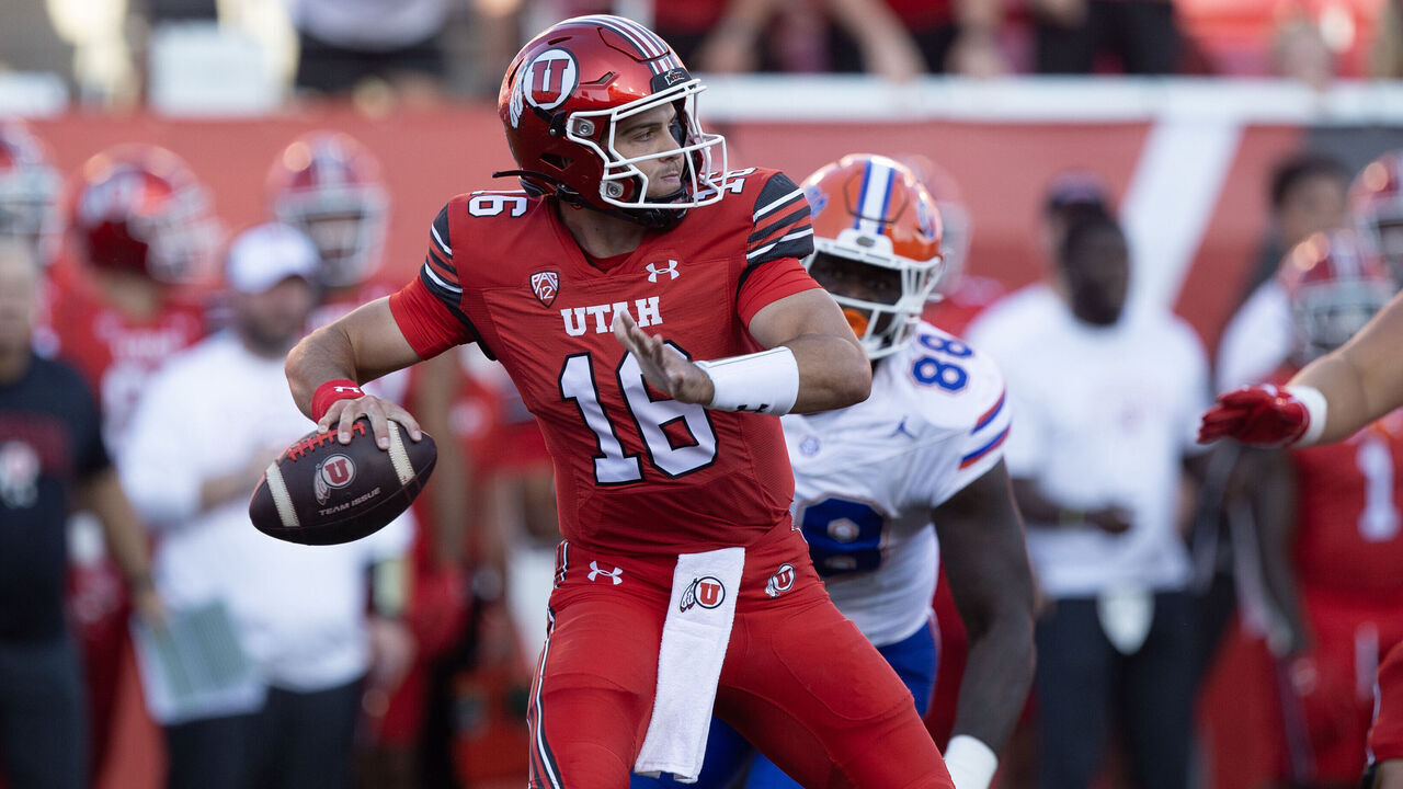 SALT LAKE CITY, UT - AUGUST 31: Bryson Barnes #16 of the Utah Utes throws a 73 yard touchdown pass under pressure from Caleb Banks #88 of the Florida Gators during the fist half of their game at Rice Eccles Stadium August 31, 2023 in Salt Lake City, Utah.