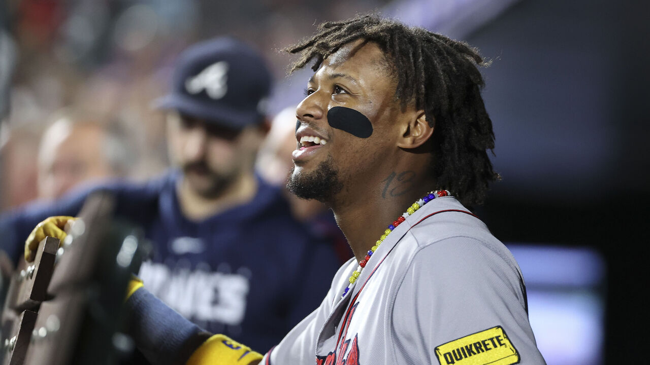 DENVER, COLORADO - AUGUST 28: Ronald Acuna Jr. #13 of the Atlanta Braves smiles from the dugout during the game against the Colorado Rockies at Coors Field on August 28, 2023 in Denver, Colorado.
